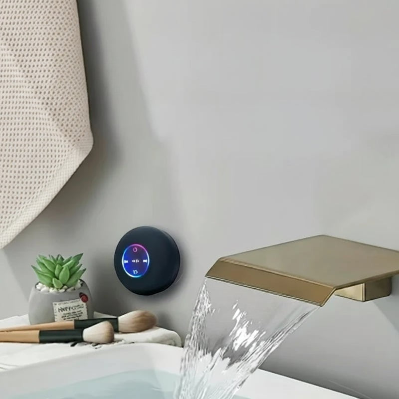 Nova Haus black portable Bluetooth speaker with suction cup mount, IPX4 waterproof, ideal for showers and bathrooms.