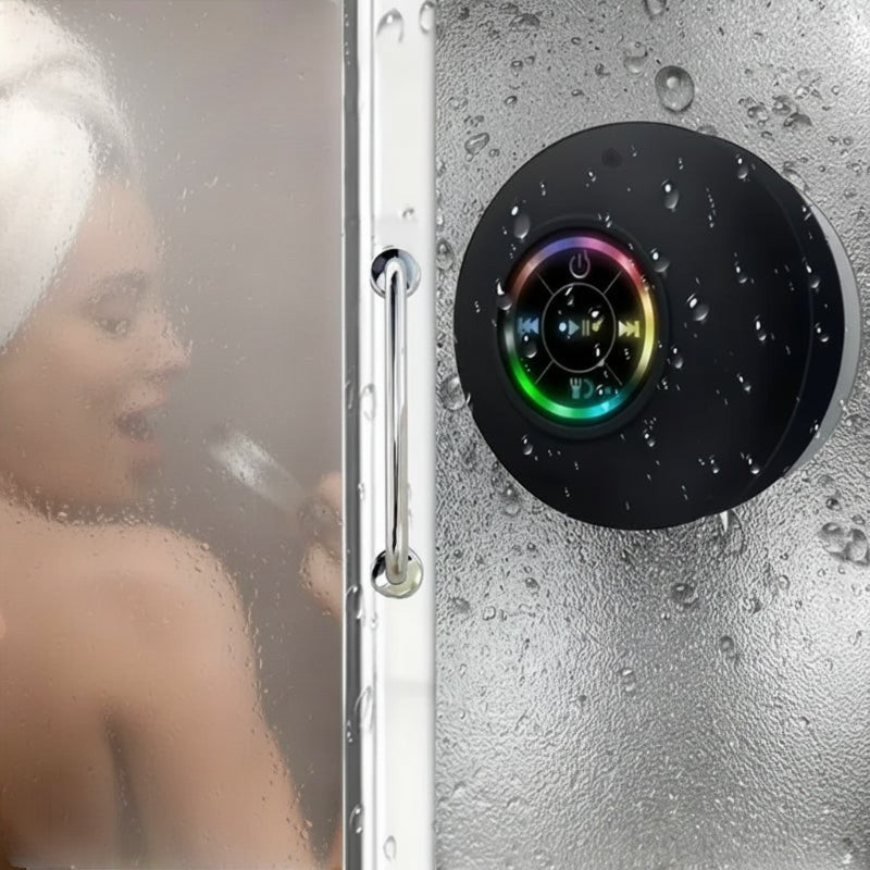 Nova Haus black waterproof Bluetooth speaker with suction cup mount and colorful LED lights, shown in a steamy shower.