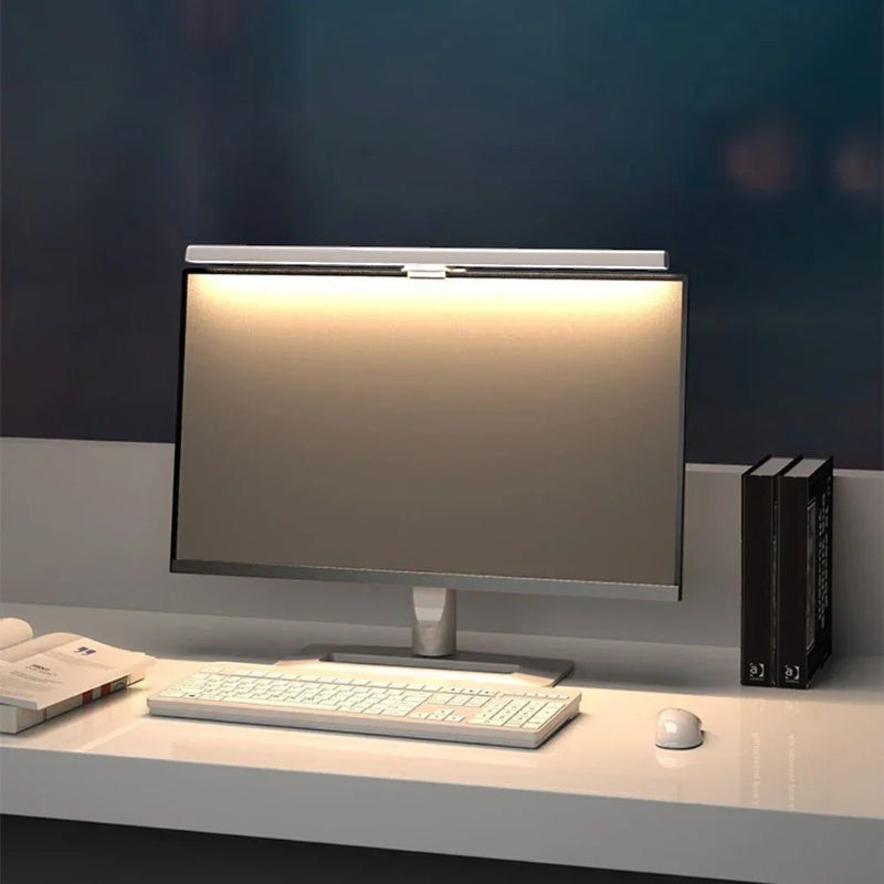 Nova Haus Aura-Beam monitor light bar in black, mounted on a computer monitor, providing glare-free illumination to the desk.